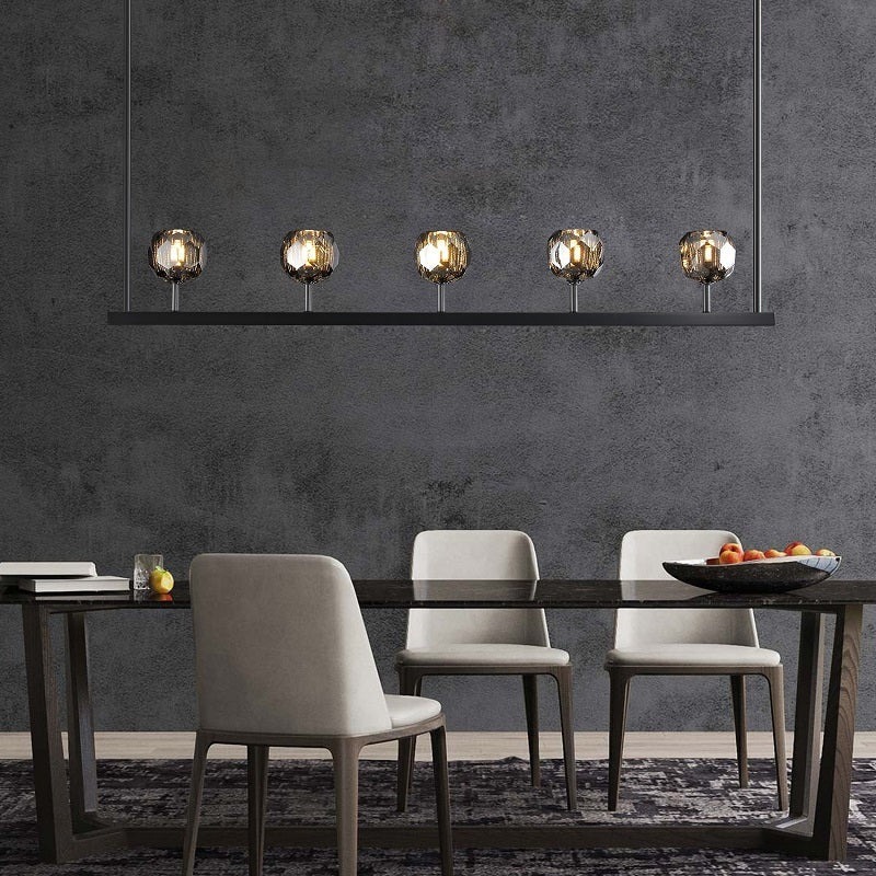 The hexagonal and pentagonal facets on the surface of the K9 glass spheres allow the warm light to reflect beautifully, creating a stunning and inviting ambiance. The overall design of the chandelier highlights its elegance and sophistication, making it a perfect addition to any room that needs a touch of glamour.