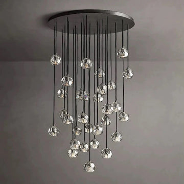 The hexagonal and pentagonal facets on the surface of the K9 glass spheres allow the warm light to reflect beautifully, creating a stunning and inviting ambiance. The overall design of the chandelier highlights its elegance and sophistication, making it a perfect addition to any room that needs a touch of glamour.