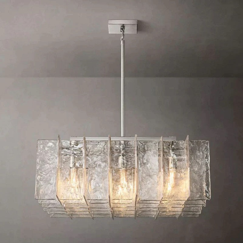 Crafted of solid cast glass, our Lattice collection's interlocking planes recall the geometric precision of the mid-century International Style. A study in repetition and rhythm, the linear form employs open space to lend a weightless feel. Gently rounded corners on the fluid, rippled panes subtly soften the outline, while diffused light glows from within.